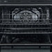 Interior view of the Forno 30-inch electric range in white, showing a spacious black enamel oven cavity with multiple wire racks and adjustable positions for flexible cooking options.