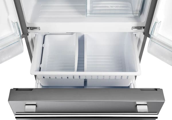 Bottom freezer drawer of the Forno 30-inch French door refrigerator in stainless steel shown open, revealing a spacious interior with deep storage compartments for organizing frozen foods efficiently.