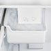Close-up view of the built-in ice maker inside the Forno 30-inch refrigerator in white, showing the ice tray and compartment designed for convenient automatic ice production.