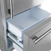 Open view of the freezer drawer in the FORNO 31-inch right-hinge refrigerator in stainless steel, showcasing the spacious lower compartment with organized storage bins for frozen items.