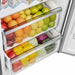 Detailed view of a lower interior drawer in the FORNO 60-inch built-in pro-style refrigerator from the 2-Piece Appliance Package, featuring a transparent design with smooth rails for easy access to produce or deli storage in a well-lit, organized compartment.