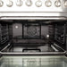 Interior view of the FORNO 36-inch gas range convection oven, featuring multiple racks and a powerful convection fan for even heat distribution.