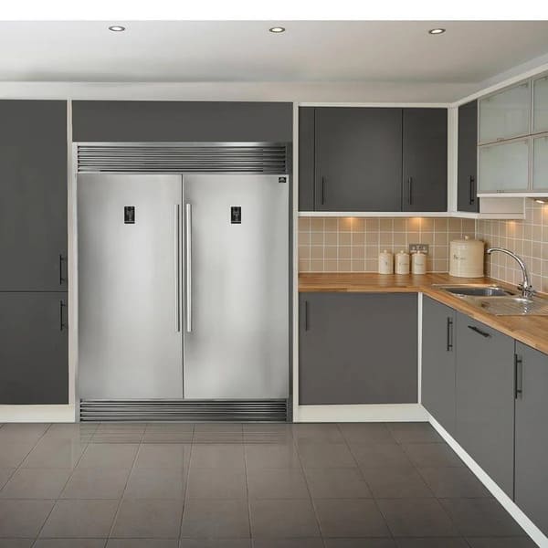Lifestyle kitchen view featuring the FORNO pro-style refrigerator and freezer from the 3-Piece Appliance Package, shown side by side in a built-in configuration with sleek stainless steel doors, vertical handles, and spacious interiors—designed for premium food storage in a modern home.