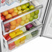Detailed view of a lower interior drawer in the FORNO pro-style refrigerator from the 3-Piece Appliance Package, featuring a transparent design with ergonomic pull handle and smooth sliding mechanism for efficient food storage and accessibility.