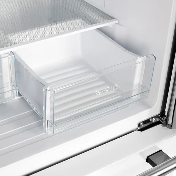 Interior view of the crisper drawer in the FORNO 30-Inch French Door Refrigerator in White, designed to keep fruits and vegetables fresh with adjustable humidity control.