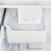 Close-up view of the built-in ice maker inside the FORNO 30-Inch French Door Refrigerator in White, showing the compact design and ice storage compartment for convenient access.