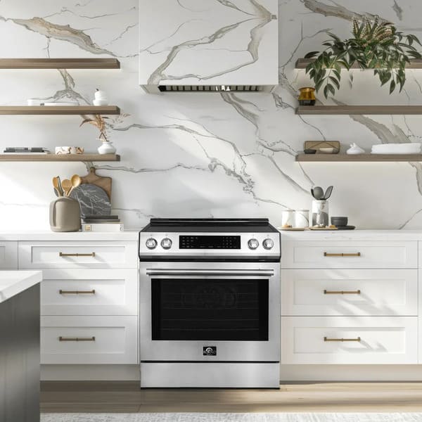 Lifestyle view of the FORNO 30-inch induction range in stainless steel, installed in a modern kitchen setting with complementary cabinetry and appliances.