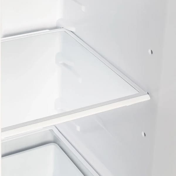Interior view of a shelf inside the FORNO 36-inch side-by-side refrigerator in stainless steel, showcasing adjustable glass shelving and spacious storage layout.