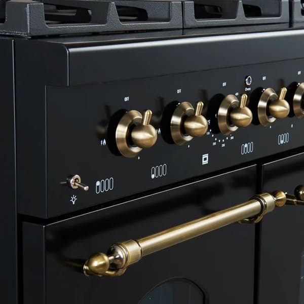 Close-up view of the control knobs on the FORNO Antico 48-Inch Dual Fuel Range in black, featuring polished brass bezels, precision temperature markings, and a sleek black stainless steel panel.