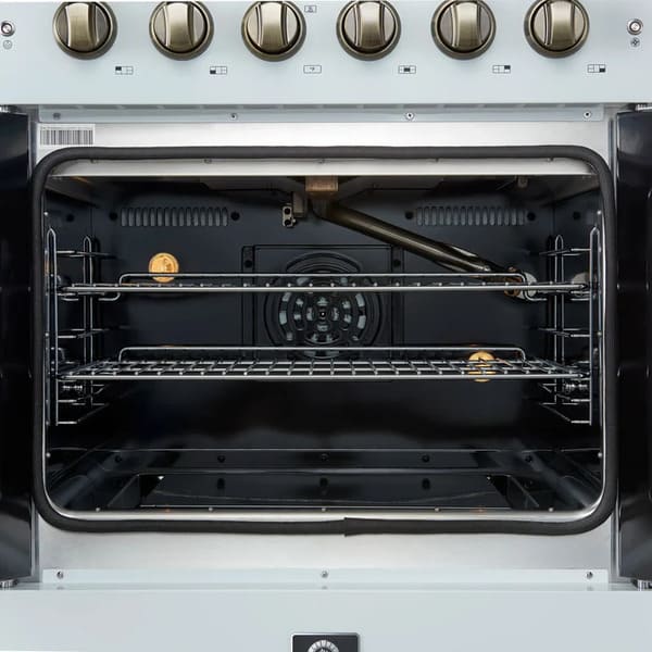 Interior view of the FORNO Galiano 30-Inch French Door Gas Range in white, highlighting the vibrant blue enamel cavity, convection fan, and multiple chrome oven racks for flexible, even cooking.