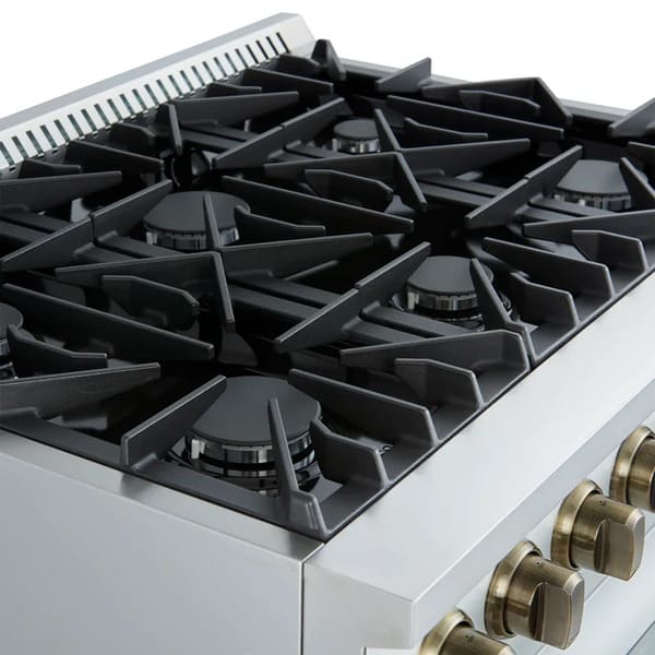 Left-angled close-up of the FORNO Marco 36-Inch Gas Range in white, featuring six brass burners with precision flame control and continuous cast iron grates on a sleek white cooktop surface.