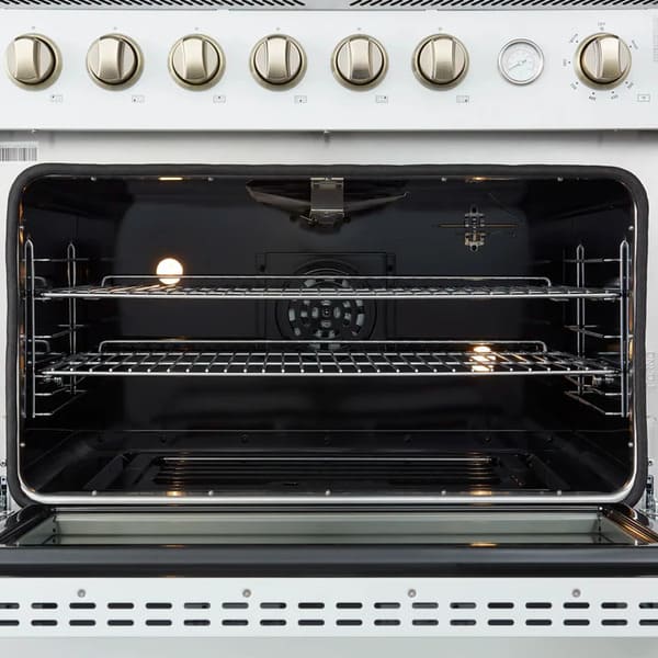 Interior view of the FORNO Marco 36-Inch Gas Range in white, showcasing the vibrant blue enamel cavity, convection fan, and multiple chrome oven racks for versatile and even cooking.