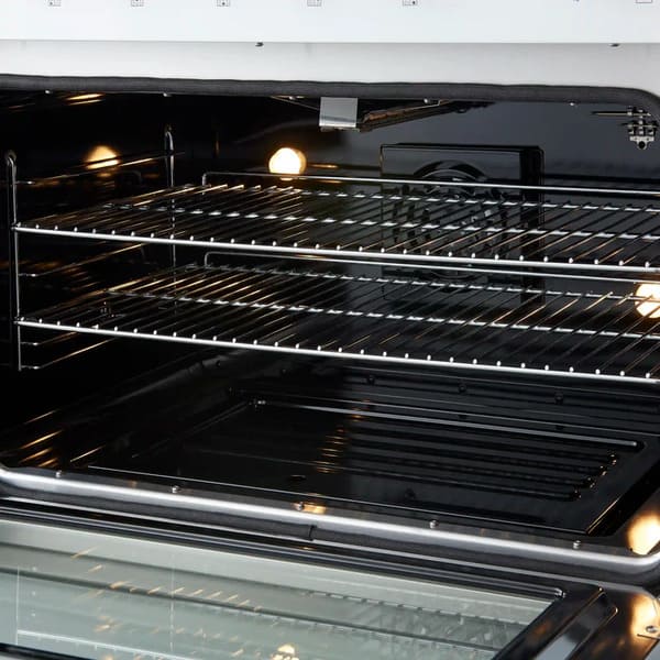 Right-angled interior view of the FORNO Marco 36-Inch Gas Range in white, highlighting the blue enamel oven interior, convection fan, and adjustable chrome racks designed for multi-level baking and roasting.