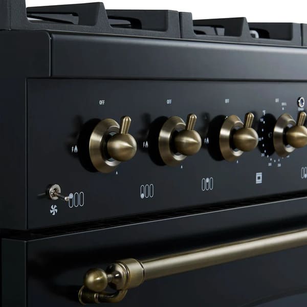 Close-up of the control knobs on the Forno Antico 36-Inch Dual Fuel Range, featuring brass bezels, precise heat markings, and a premium stainless steel panel for a refined cooking experience.