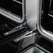 Close-up view of the oven door hinges on the Forno Antico 48-Inch Gas Range, showing robust construction designed for smooth, stable door operation and long-term durability.