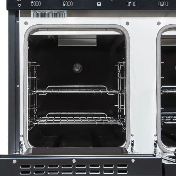 Interior view of the secondary oven in the Forno Antico 48-Inch Gas Range, featuring a blue enamel finish, convection fan, and heavy-duty oven racks for flexible cooking options.