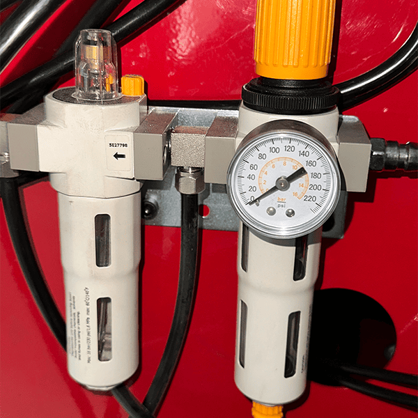 Air pressure regulator and gauge assembly on KT-T855 tire changer with dual filter system.