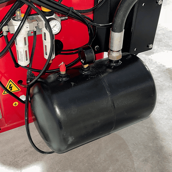 Close-up of KT-T855 tire changer air tank and hoses for pneumatic operation.