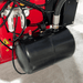 Close-up of KT-T855 tire changer air tank and hoses for pneumatic operation.