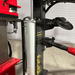 Hydraulic assist arm and cylinder mechanism on KT-T855 tire changer for efficient tire handling.