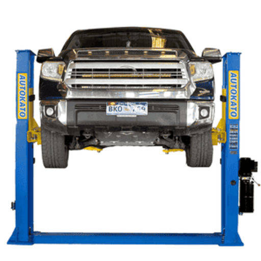 Katool H115Z 11,000 lb 2 post car lift hoisting a full-size truck in auto repair shop.