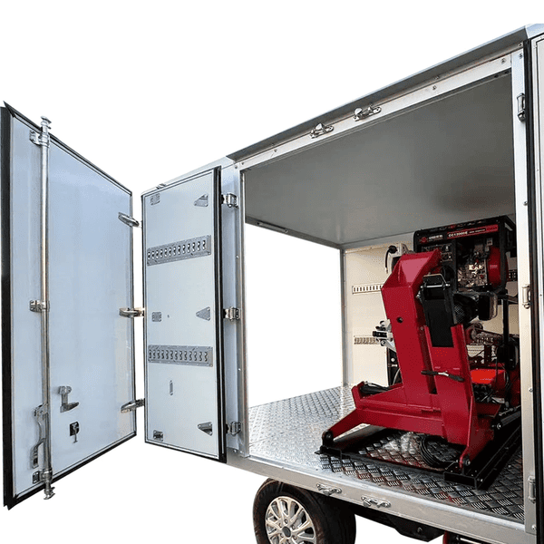 Katool KT-308 automatic tire changer securely installed inside a mobile workshop trailer for on-site tire service.