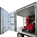 Katool KT-308 automatic tire changer securely installed inside a mobile workshop trailer for on-site tire service.