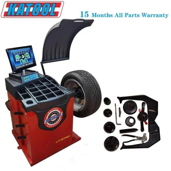 Katool KT-B750 wheel balancer with mounted wheel, protective hood, and included accessories, backed by 15 months warranty.