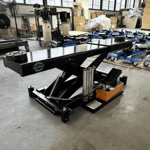 Katool KT-RJ70 air hydraulic rolling jack with 7,000 lb lifting capacity shown in a workshop setting.