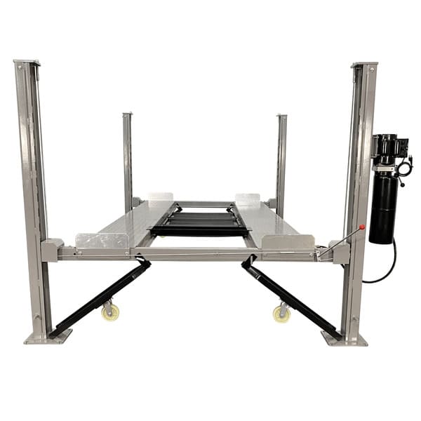 Full view of the Triumph NSS-8 four post automotive lift in a garage setting, showcasing its sturdy frame and design

