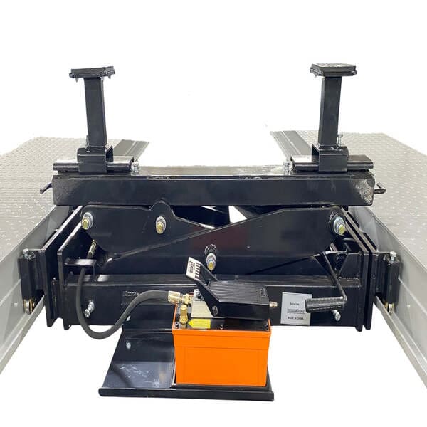 Close-up of Triumph NTR-32 four post auto lift with hydraulic jack tray for heavy vehicle service.