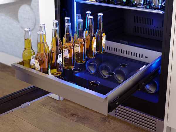 Stainless steel full-extension rollout bin inside the ZEPHYR Dual Zone Wine and Beverage Cooler.