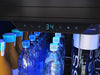Close-up of the ZEPHYR Full Size Single Zone Beverage Cooler control panel illuminated with deep blue LED lighting, highlighting touch controls and settings