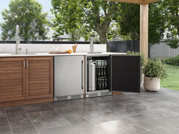 ZEPHYR Outdoor Kegerator & Beverage Cooler shown installed in an outdoor kitchen with the door open, revealing interior keg setup and LED-lit storage space