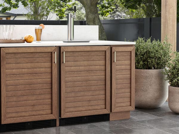 ZEPHYR Outdoor Kegerator & Beverage Cooler with custom panel kit installed, blending seamlessly with outdoor cabinetry for a built-in, integrated appearance