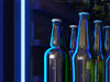 Interior of the ZEPHYR Panel Ready Full Size Beverage Cooler illuminated with deep blue LED lighting, offering a modern and stylish beverage presentation