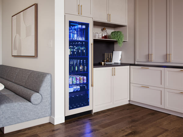 Angled view of the ZEPHYR Panel Ready Full Size Beverage Cooler installed in a modern kitchen environment, seamlessly integrated with custom cabinetry