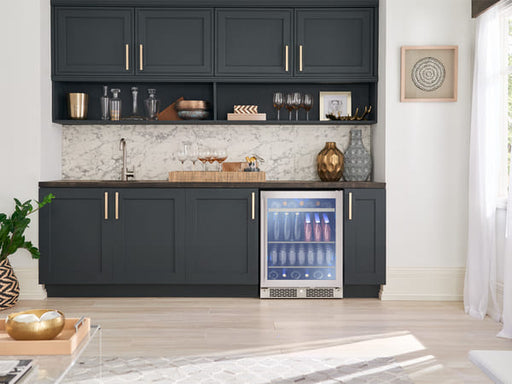 Zephyr ADA-compliant single zone beverage cooler installed under a kitchen counter, seamlessly integrated into modern cabinetry with a glass door and soft interior lighting visible.
